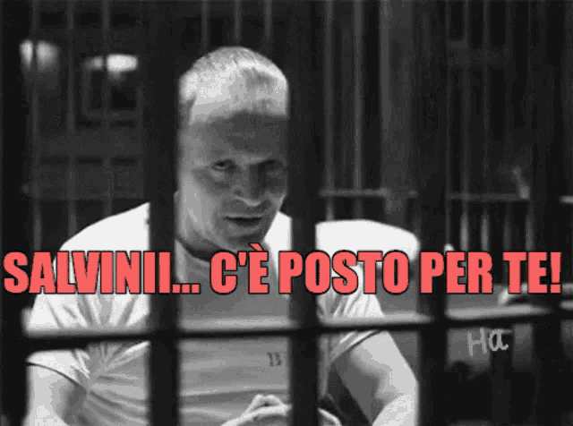 a man behind bars with the words salvinii c ' e posto per te written in red