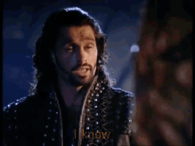 a man with long hair and a beard says i know .