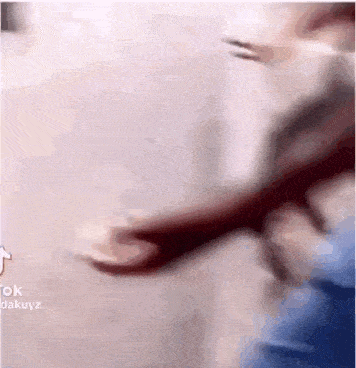 a blurry picture of a person 's hand reaching for something .