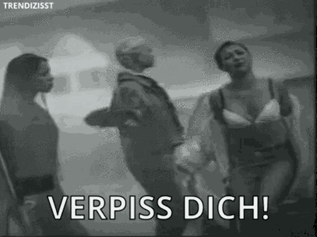 a black and white photo of a group of people standing next to each other with the words verpiss dich written on the bottom .