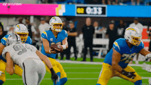 a football game is being played with a hyundai ad in the background
