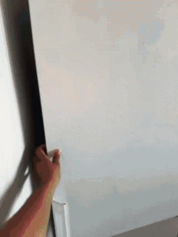 a person is opening the door of a refrigerator