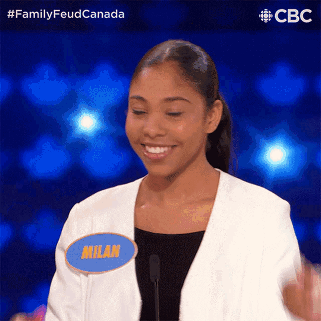 a woman wearing a name tag that says milan on it