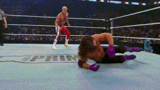 a wrestler is laying on the ground in a wrestling ring with the word april on the floor