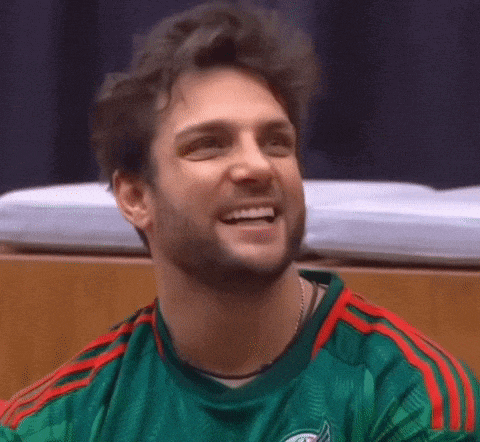 a man with a beard is wearing a green and red striped shirt .