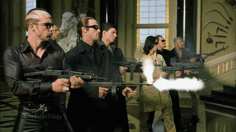 a group of people holding guns with the matrix trilogy written on the bottom right
