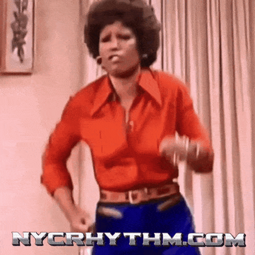 a woman in a red shirt and blue pants is dancing in front of a nycrhythm.com logo .