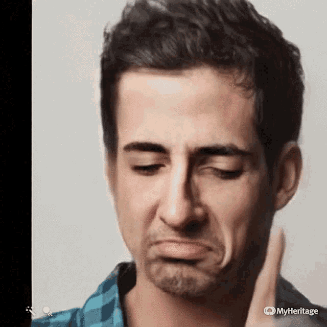 a close up of a man 's face with a myheritage logo in the corner
