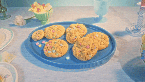a white plate with a cookie on it that has candy on it