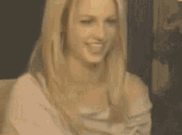 a woman is laying on a bed with her mouth open .
