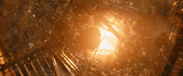 a glowing light is shining through a broken glass window