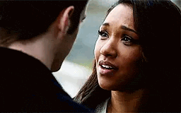 a man and a woman are looking at each other . the woman is crying and the man is smiling .