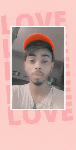 a man wearing a red hat is standing in front of a pink background with the word love on it