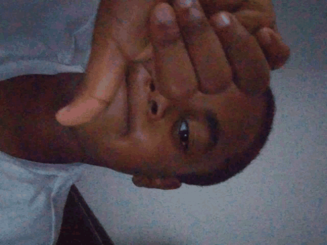 a man is covering his face with his hand
