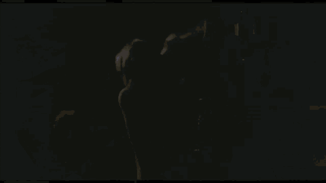 a close up of a person 's face in the dark in a dark room .