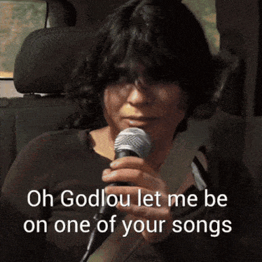 a woman singing into a microphone with the words " oh godlou let me be on one of your songs " below her