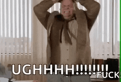 a man in a suit and tie is holding his head and screaming .