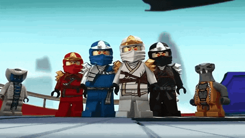 a group of lego ninjago characters are standing next to each other .