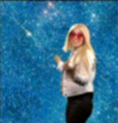 a blurry picture of a woman wearing sunglasses and a white shirt