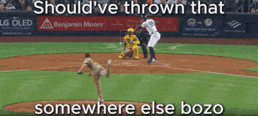 a baseball game is being played with a benjamin moore ad behind the pitcher