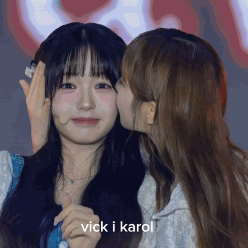 a girl kissing another girl on the cheek with the words vick i karol written below