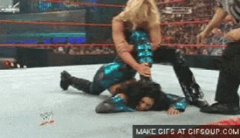two women wrestling in a ring with a make gifs at gifsoup.com logo