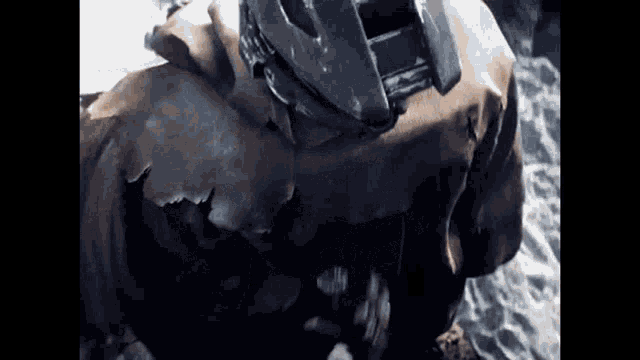 a statue of a man with a helmet on his head is laying on the ground .