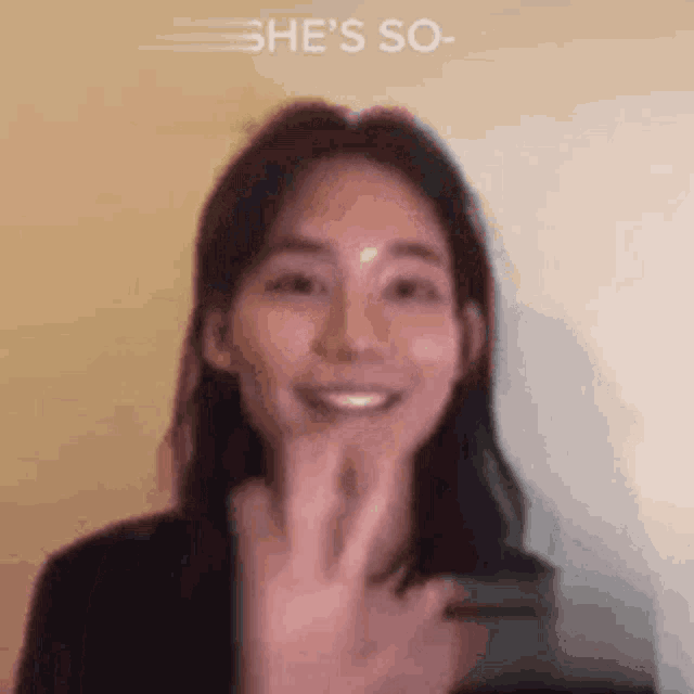 a close up of a woman 's face with the words `` she 's so '' written on the bottom .