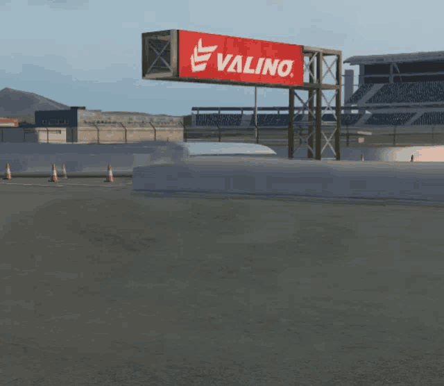a white van is driving down a road in front of a billboard for valino
