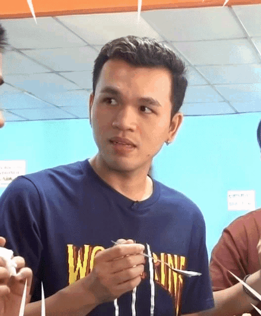 a man wearing a blue shirt that says ' wo ' on it