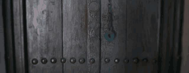 a woman in a blue robe is standing in front of a door