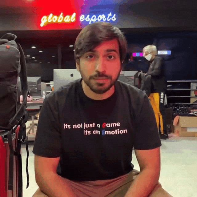 a man wearing a black t-shirt that says it 's not just a game it 's an emotion