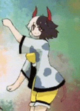 a cartoon girl with horns is dancing in a polka dot dress .
