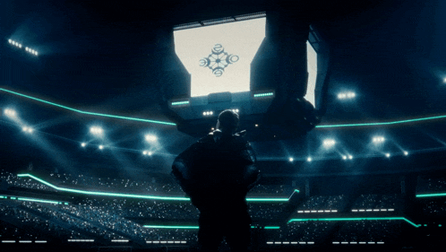 a man stands in front of a large screen that says ' champions '