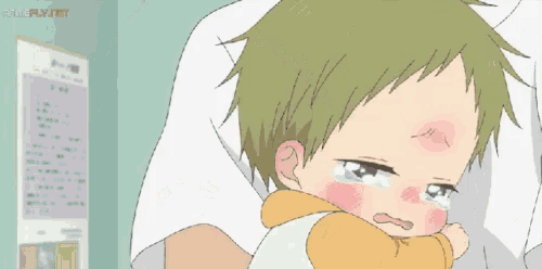 a baby is crying while being held by a person