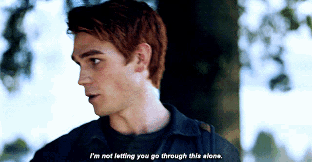 a man in a black shirt says " i 'm not letting you go through this alone "