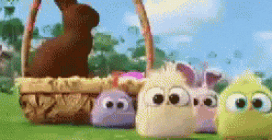 a group of stuffed animals are standing next to a basket of easter eggs .