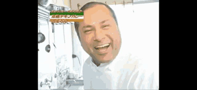 a man in a white shirt is smiling in front of a sign that says ' chicken curry '