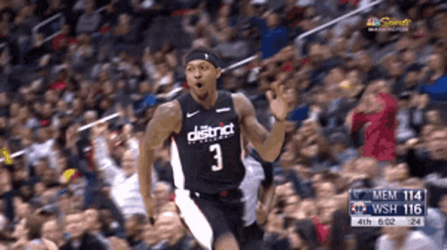 a basketball player with the number 3 on his jersey is running in front of a crowd