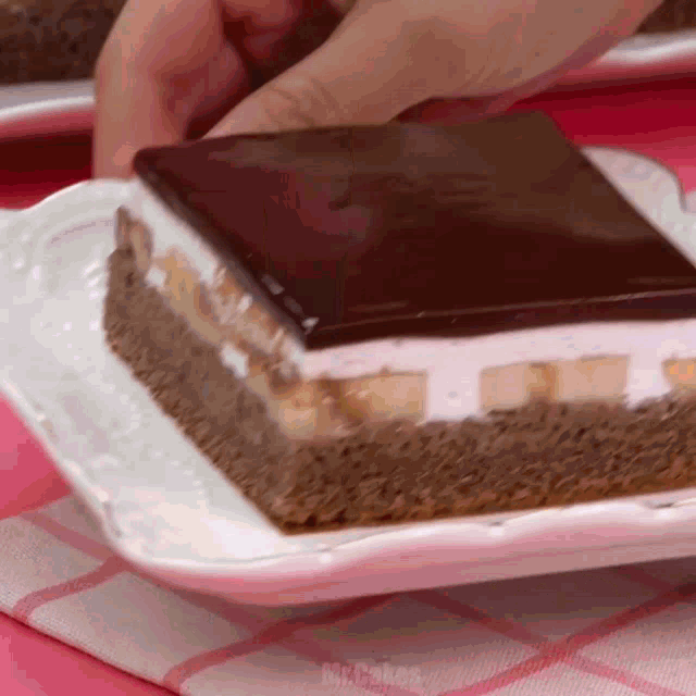 a white plate with a piece of cake on it that says mr.cakes