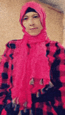 a woman wearing a pink scarf and hijab
