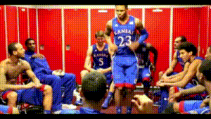 a man in a kansas jersey jumps in the air