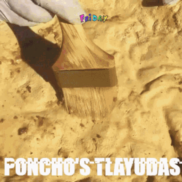 a person is using a brush on a sandy surface with the words poncho 's tlayudas written below it