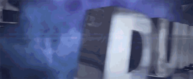 a close up of a person 's face with a blue background and a blurred image of a person 's face .
