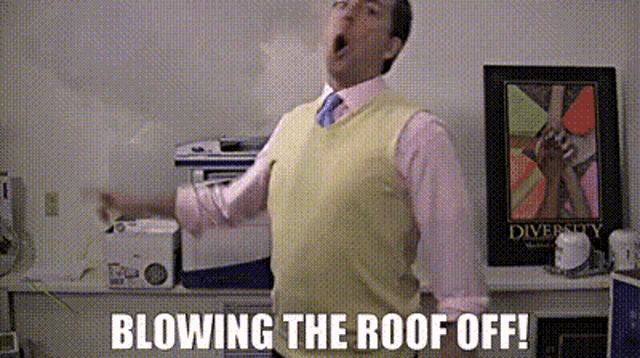 a man is blowing the roof off in front of a poster for diversity