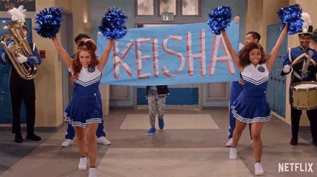 cheerleaders holding a banner that says keisha on it
