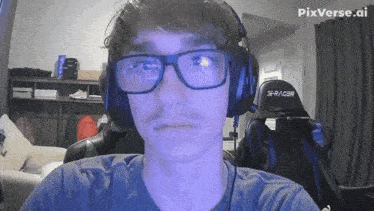 a man wearing glasses and headphones with the word racer on the back of his chair