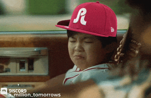 a little boy wearing a pink hat with a letter r on it