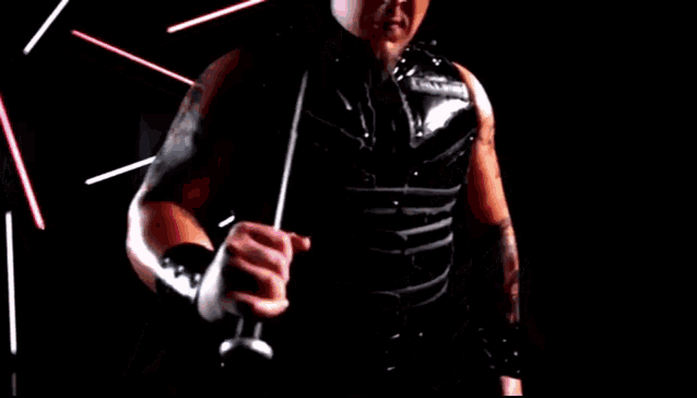 a man in a black leather vest with the word challenge on it