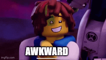 a lego character is smiling and says `` awkward '' while sitting in a chair .